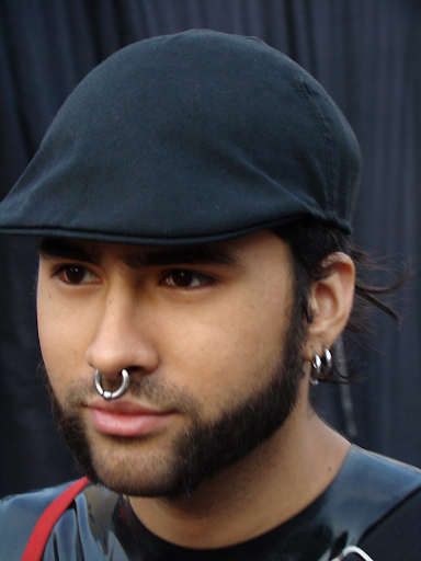 A person with ear and nose piercings