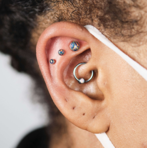 Ear with several kinds of piercings